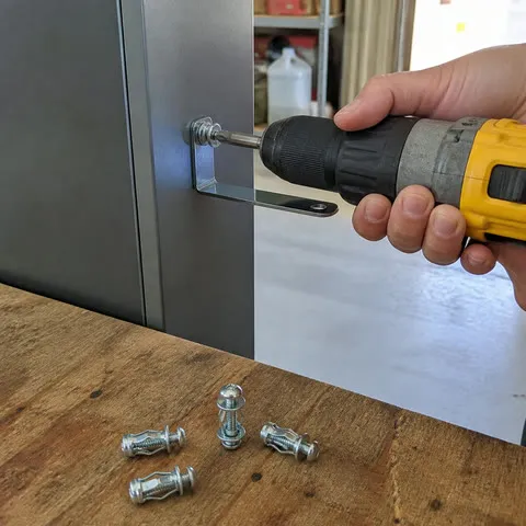 Installing a bracket on a metal cabinet in a home garage