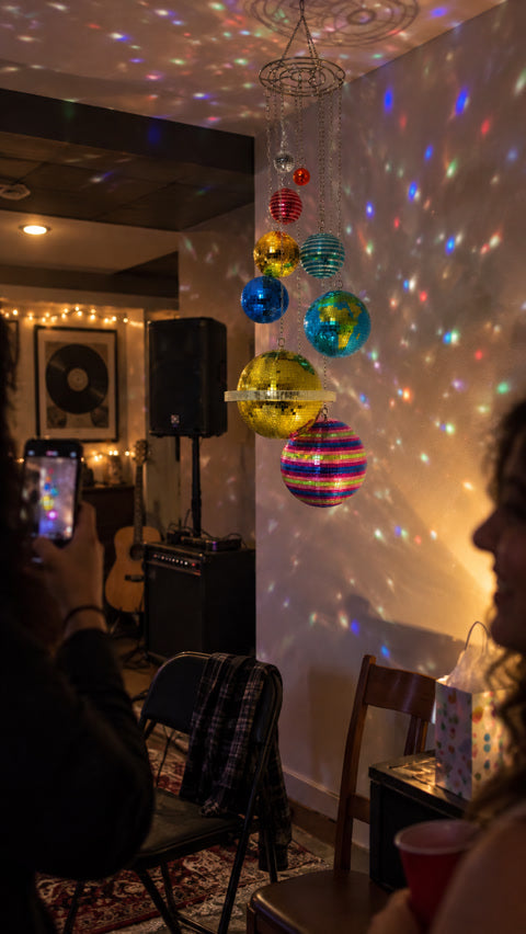 Colorful hanging planet mobile in a casual music room