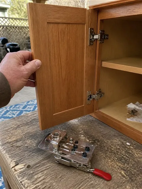 Finished concealed hinges on a small cabinet door