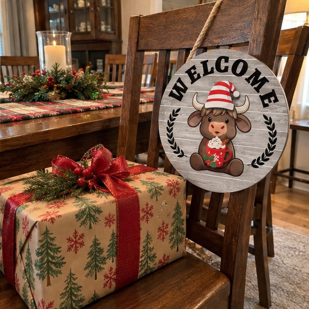 Snowy Gray welcome sign displayed beside a wrapped Christmas gift