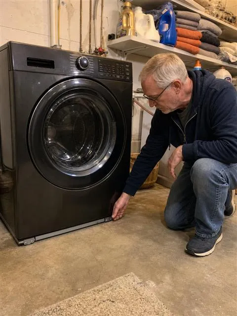 Checking the low support rail beneath a washer