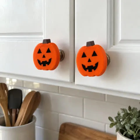 Pumpkin accents on white kitchen cabinet knobs