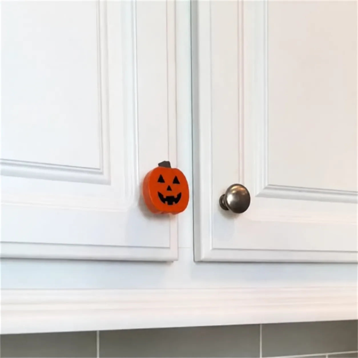 Pumpkin cover installed beside a round cabinet knob