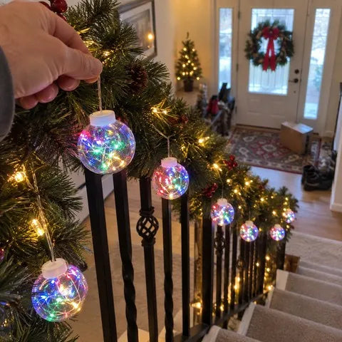 Multicolor crackle globe lights arranged along a lived-in staircase garland