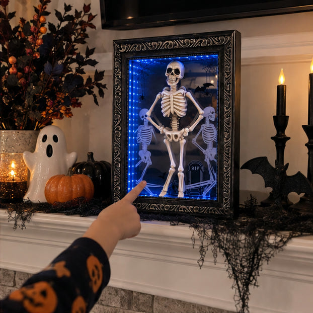 Child pointing at the lighted skeleton frame on a Halloween mantel