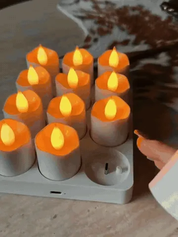 Rechargeable candles being lifted from their charging base and controlled with the remote