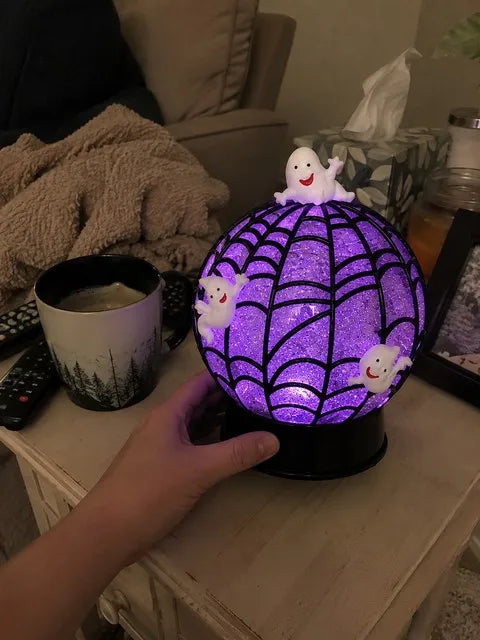 Ghost glitter globe glowing on a family living room side table
