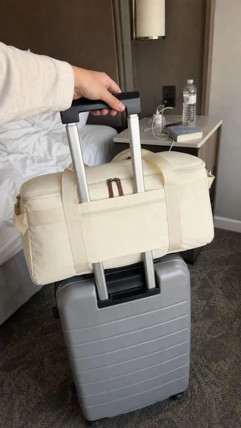 Rear trolley sleeve secured around a suitcase handle in a hotel room