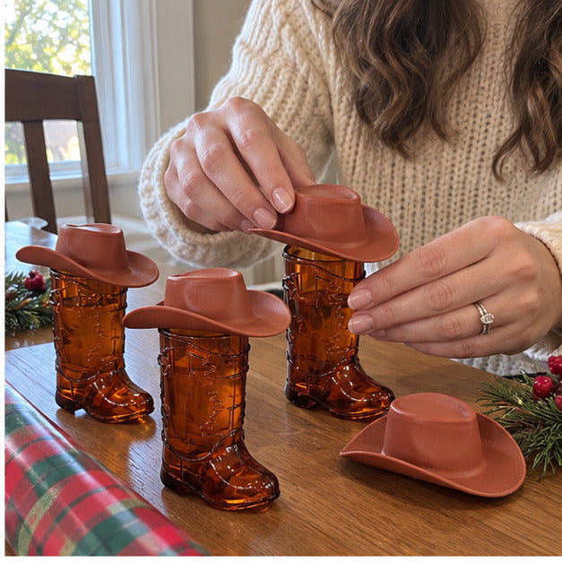Adult placing brown mini hats on amber boot cups
