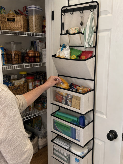 Pantry door organizer holding snacks and kitchen supplies