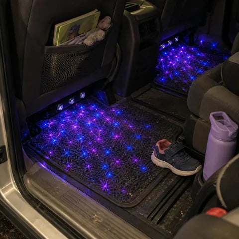 Blue and purple star lighting in a family minivan rear footwell