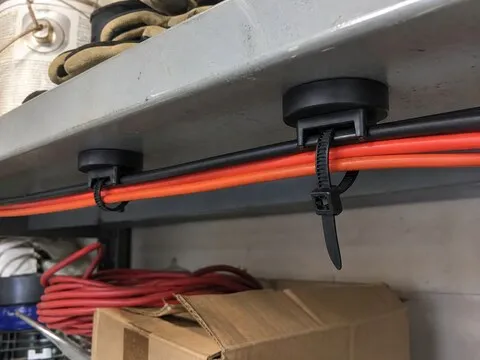 Customer-style photo of cables routed along a garage shelf