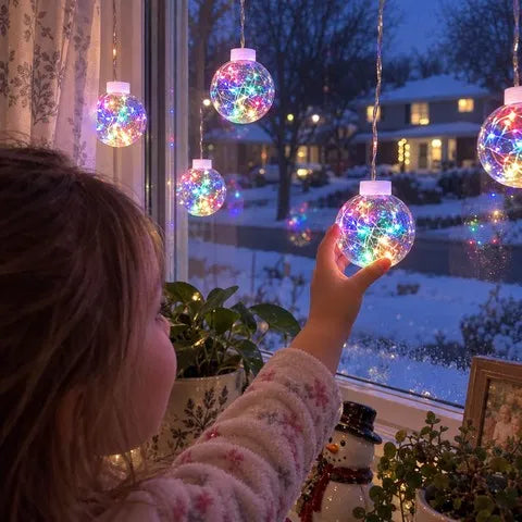 Child enjoying colorful crackle globe lights in a snowy front window