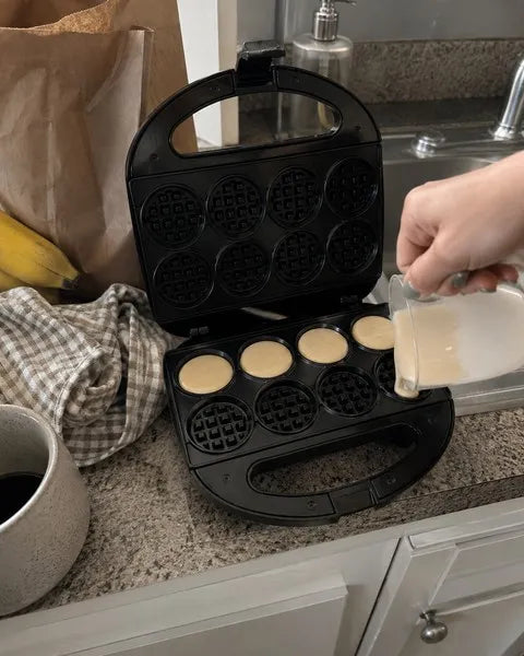 Mini waffle maker on a lived-in apartment kitchen counter