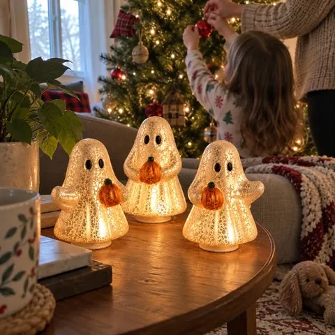 Glowing ghost decorations beside a family Christmas tree