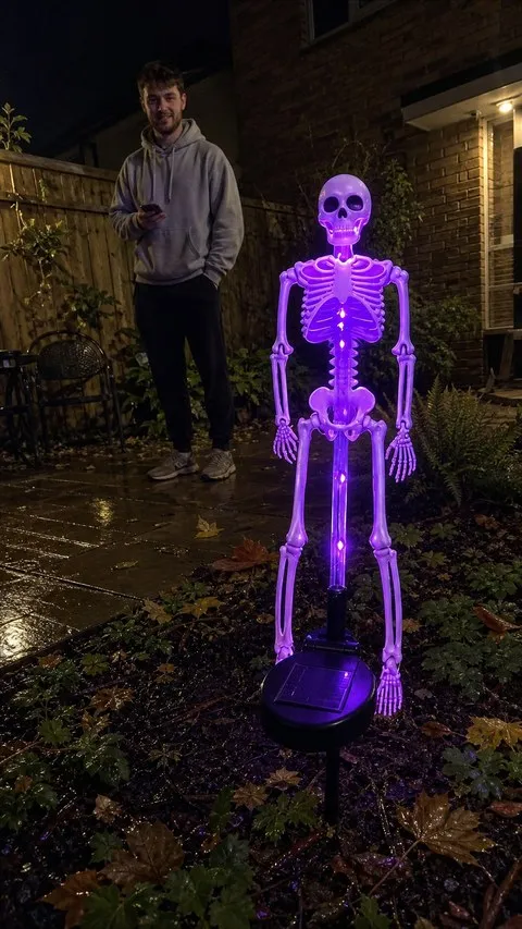 Purple solar skeleton yard stake in a townhouse garden