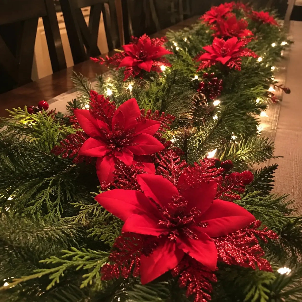 Poinsettia clips styled along a holiday table garland