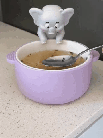 Elephant fan clipped to a bowl while food is stirred