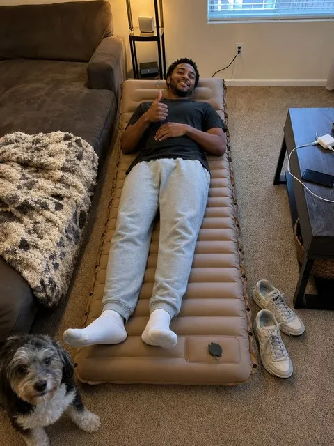 Customer-style snapshot of the camping mattress used as a guest bed