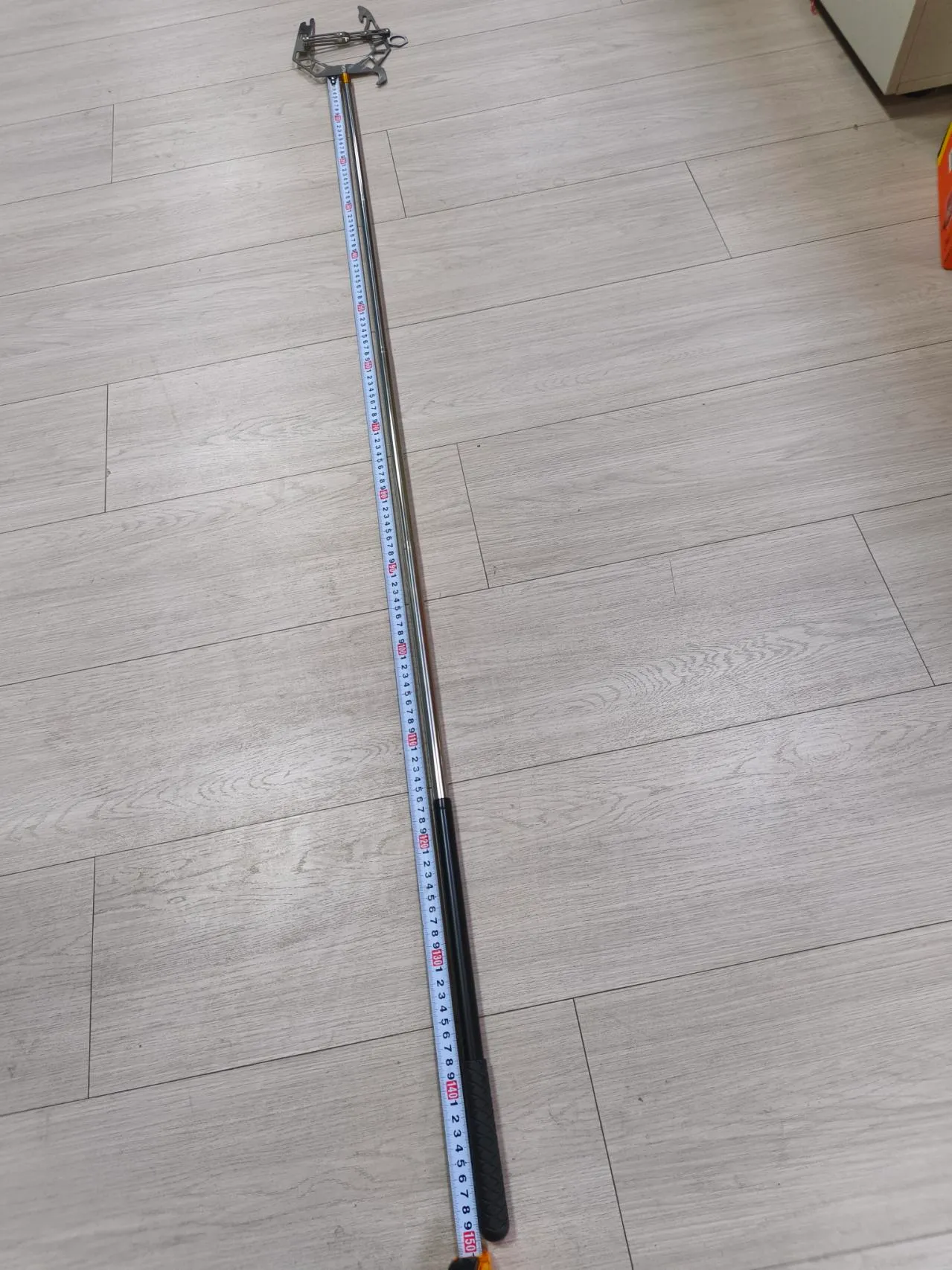 Boater demonstrating the adjustable length of a mooring hook