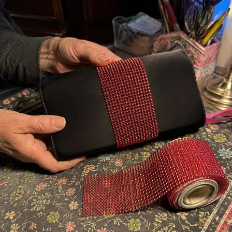 Red rhinestone tape decorating a black clutch