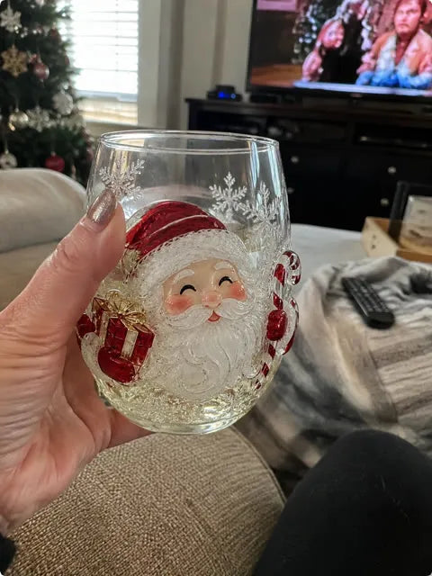 Santa glass held near an armchair during a holiday movie