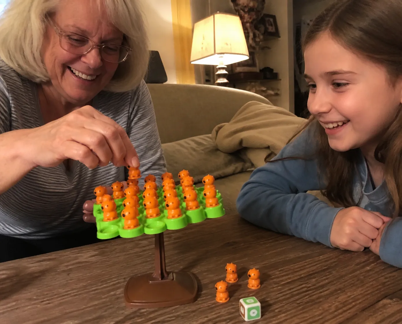 Grandparent and child enjoying the capybara balance game