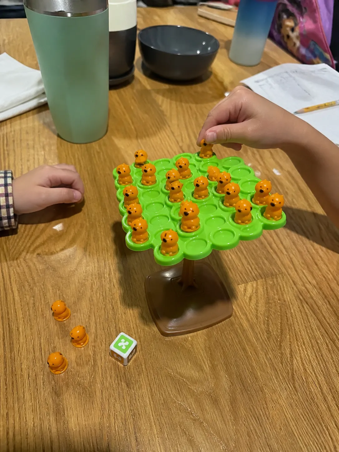 Children playing the balance game at a kitchen table