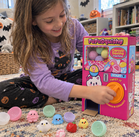A child turning the capsule machine knob during playtime