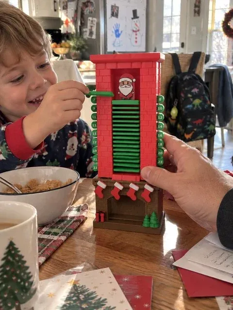 Family using the Santa chimney countdown during breakfast