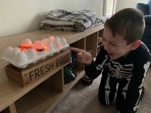 Child reacting to the glowing zombie chick egg display