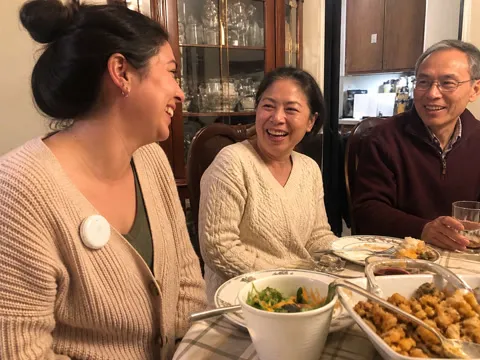 Family using the translator during dinner