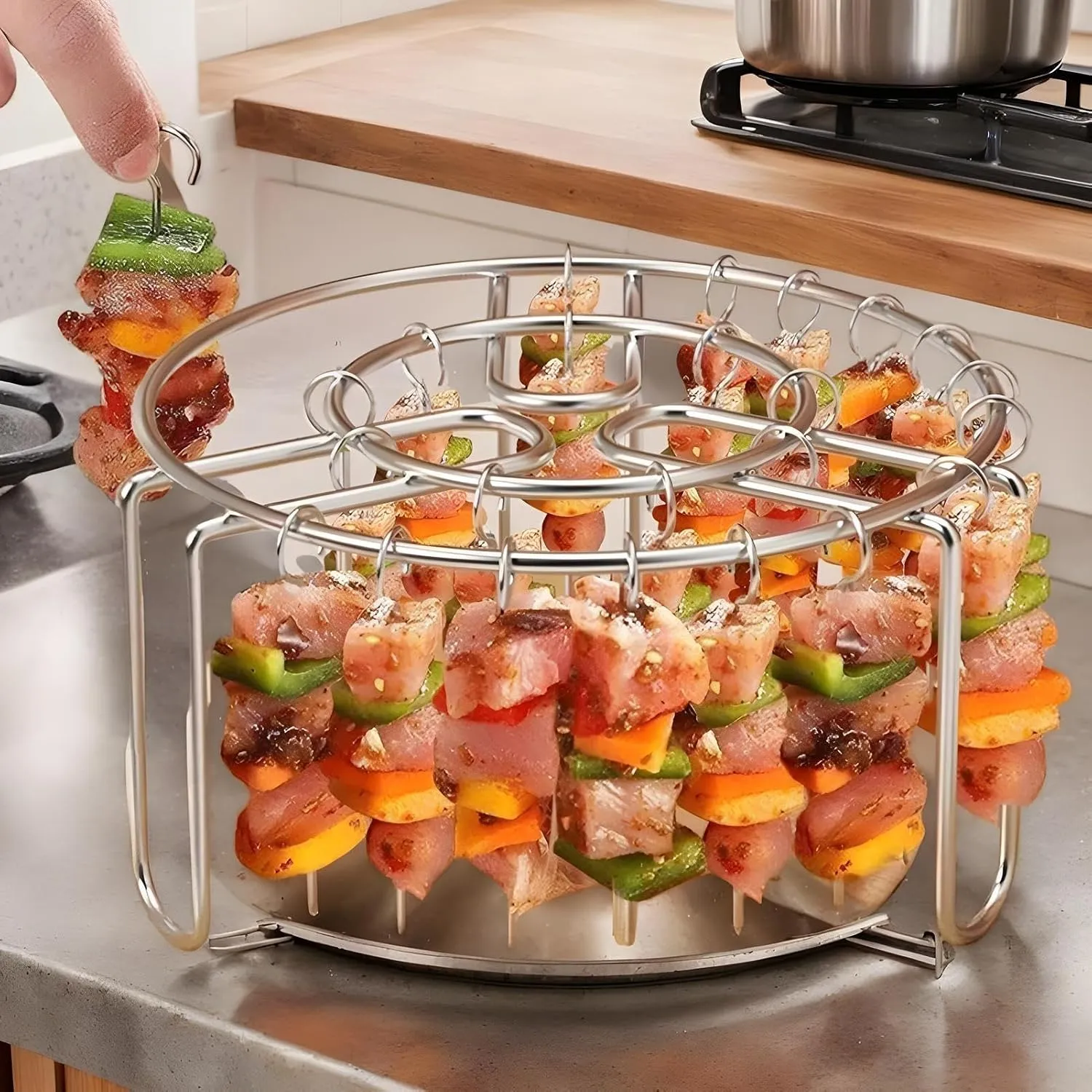 Hand loading food onto the hanging skewer rack