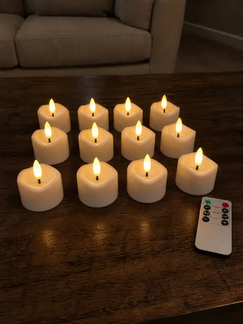 Warm flameless candles on an apartment coffee table