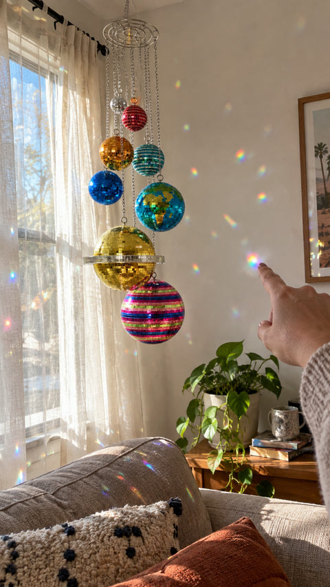 Colorful reflections from the hanging mobile in a sunlit apartment