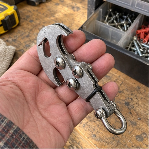 Folded hook held above an everyday garage workbench
