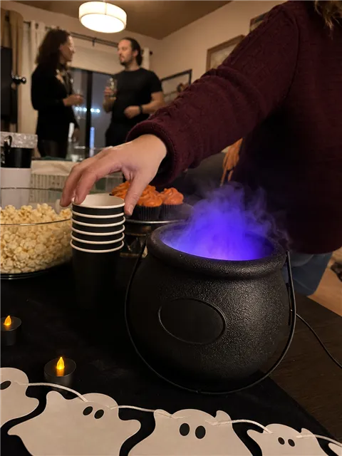 Casual Halloween party buffet with a glowing cauldron
