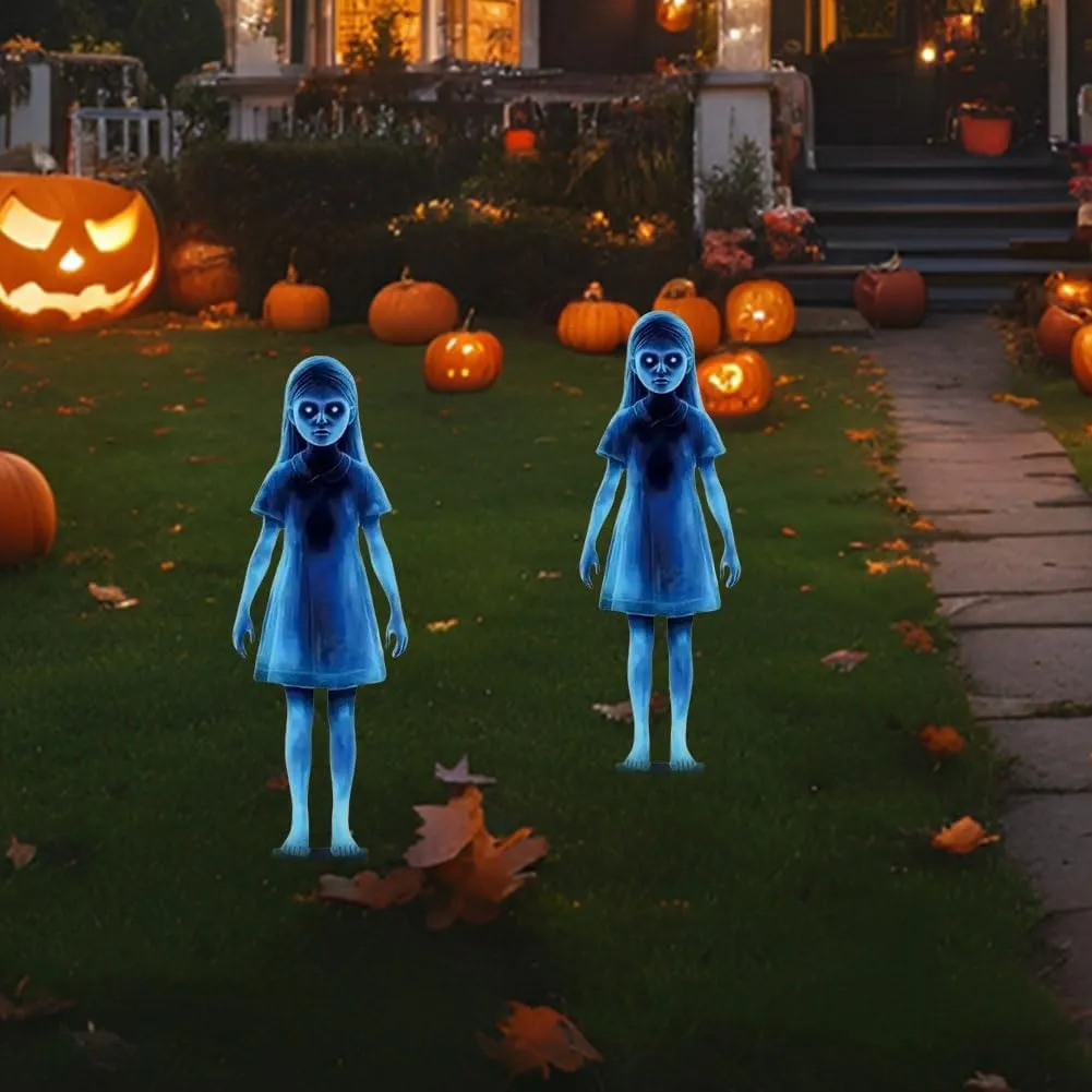 Two blue ghost-girl stakes in a pumpkin-decorated front yard