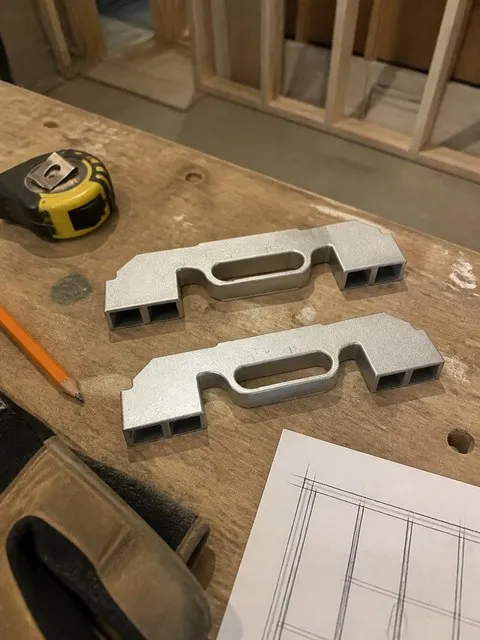 Two framing layout jigs on a home workshop bench