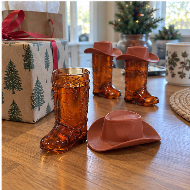 Amber boot cup and brown hat beside a wrapped Christmas gift