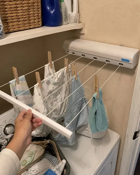Baby clothes drying in a small laundry nook