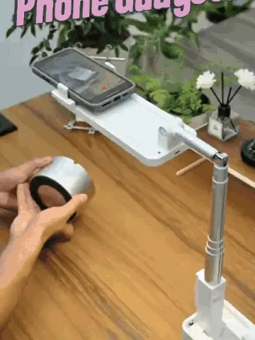 Folding phone stand moving between upright and overhead filming positions