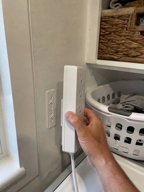 Power strip mount in a utility room