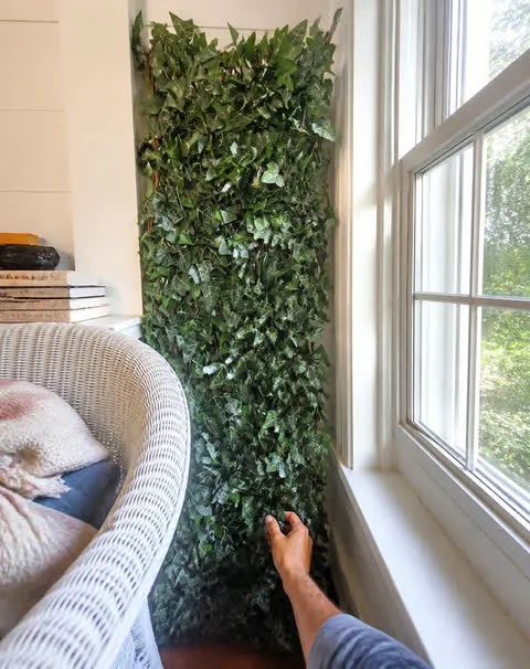 Faux ivy panel beside a sunroom window