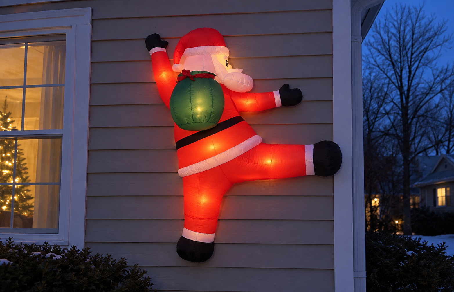 Built-in lights glowing inside the wall-climbing Santa after dark