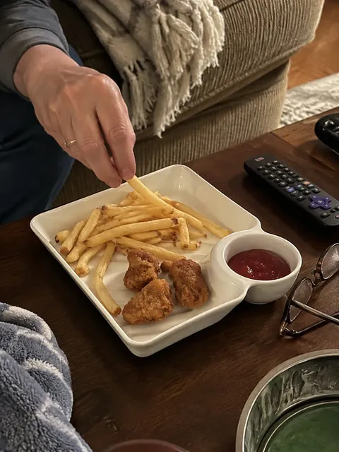 Fries and chicken bites served with ketchup during movie night