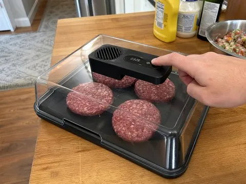 Black defrosting box used while preparing burgers