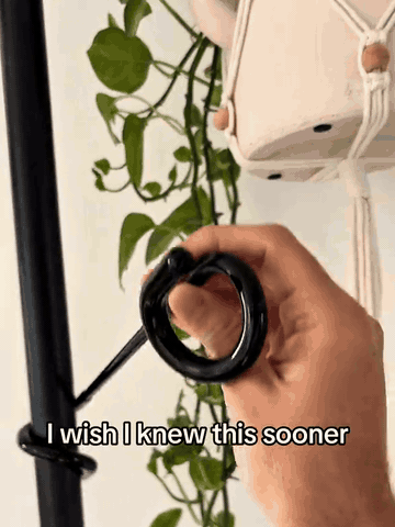 Animated demonstration of wrapping the plant hook onto a stand and hanging greenery
