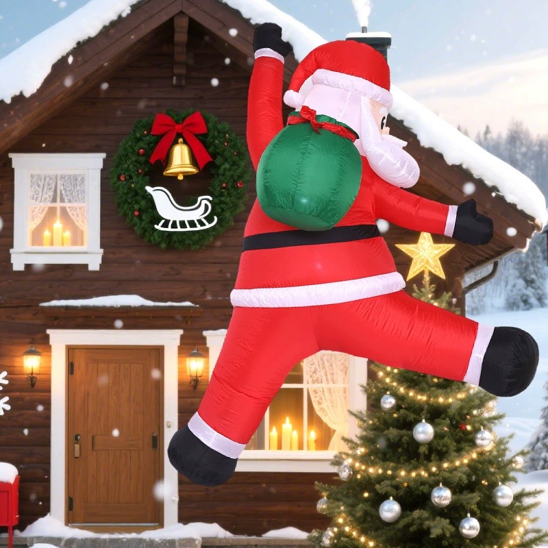 Wall-climbing Santa inflatable displayed on a snowy house exterior