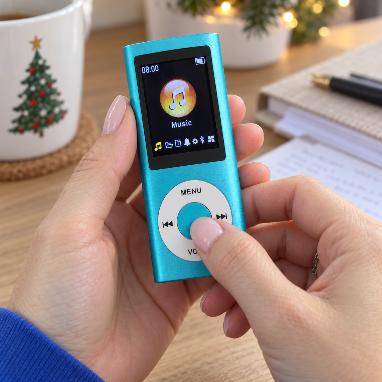 Finger using the physical controls on the blue MP3 player